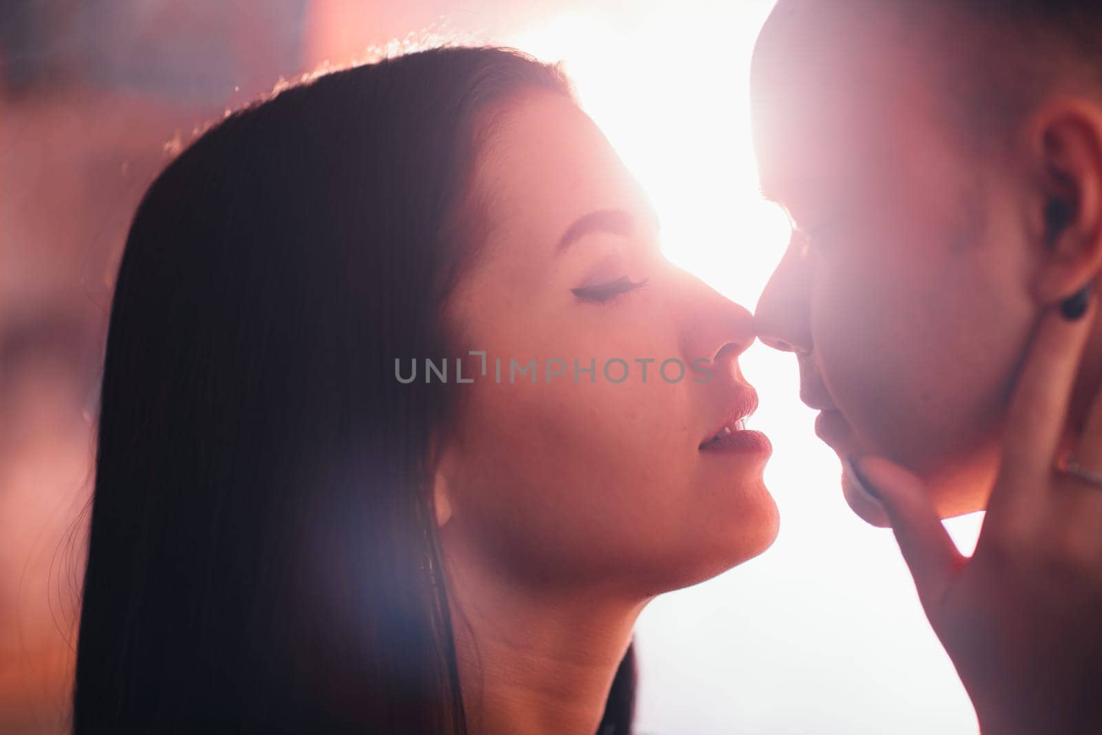 guy and the girl kiss closeup on a light background