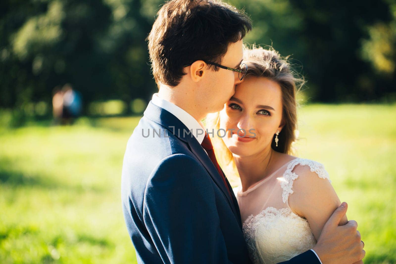 bride and groom embracing on nature background.