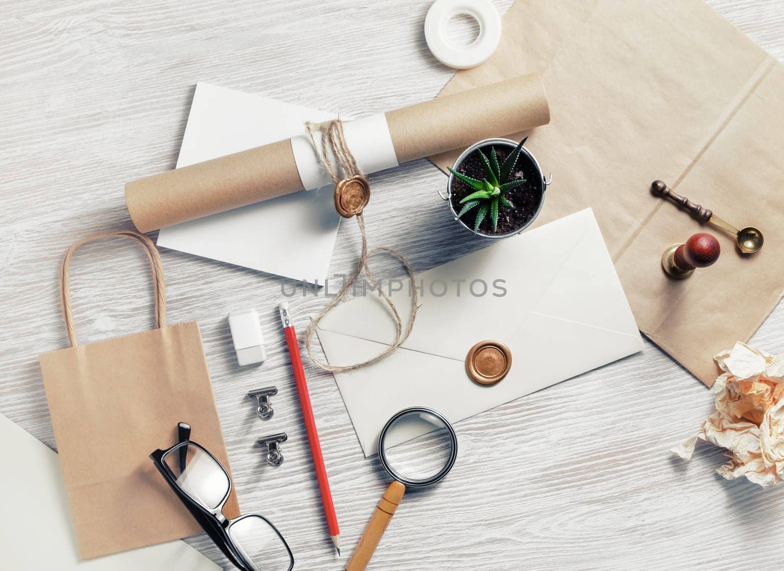Old blank retro stationery on light wood table background. Flat lay.