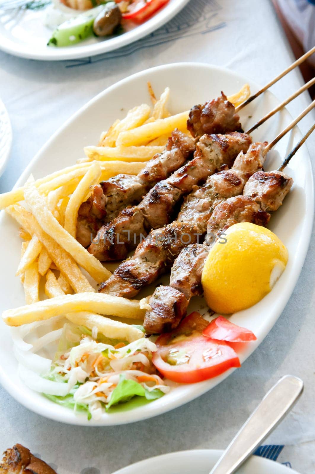 meat with potatoes and vegetables on a large plate