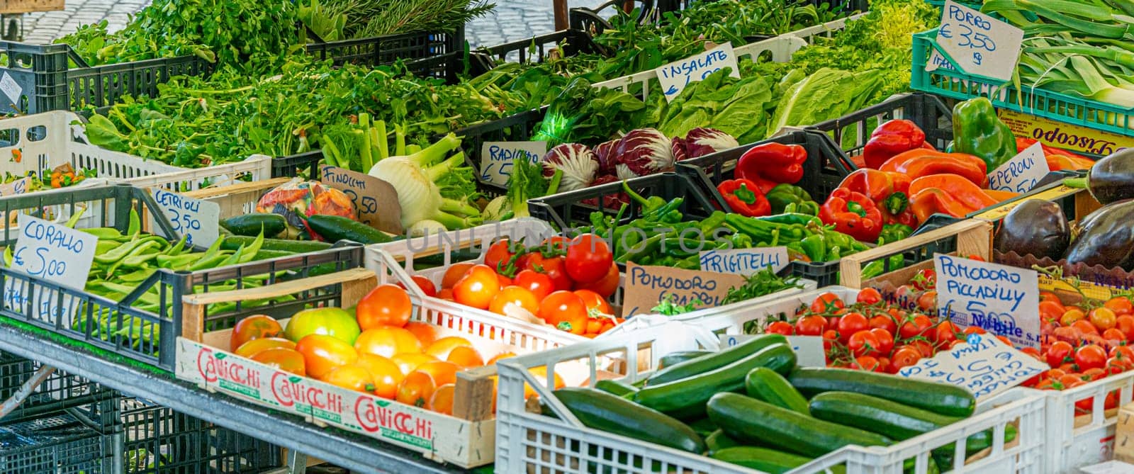 Rome, Italy, February 2017: mixed vegetables, including tomatoes, peppers and courgettes, on sale in a stand in the historic Campo de Fiori street market in Rome