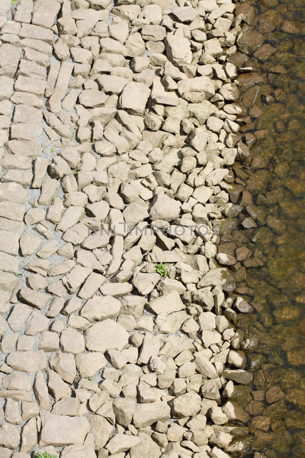 Stones at a shore embankment, background image