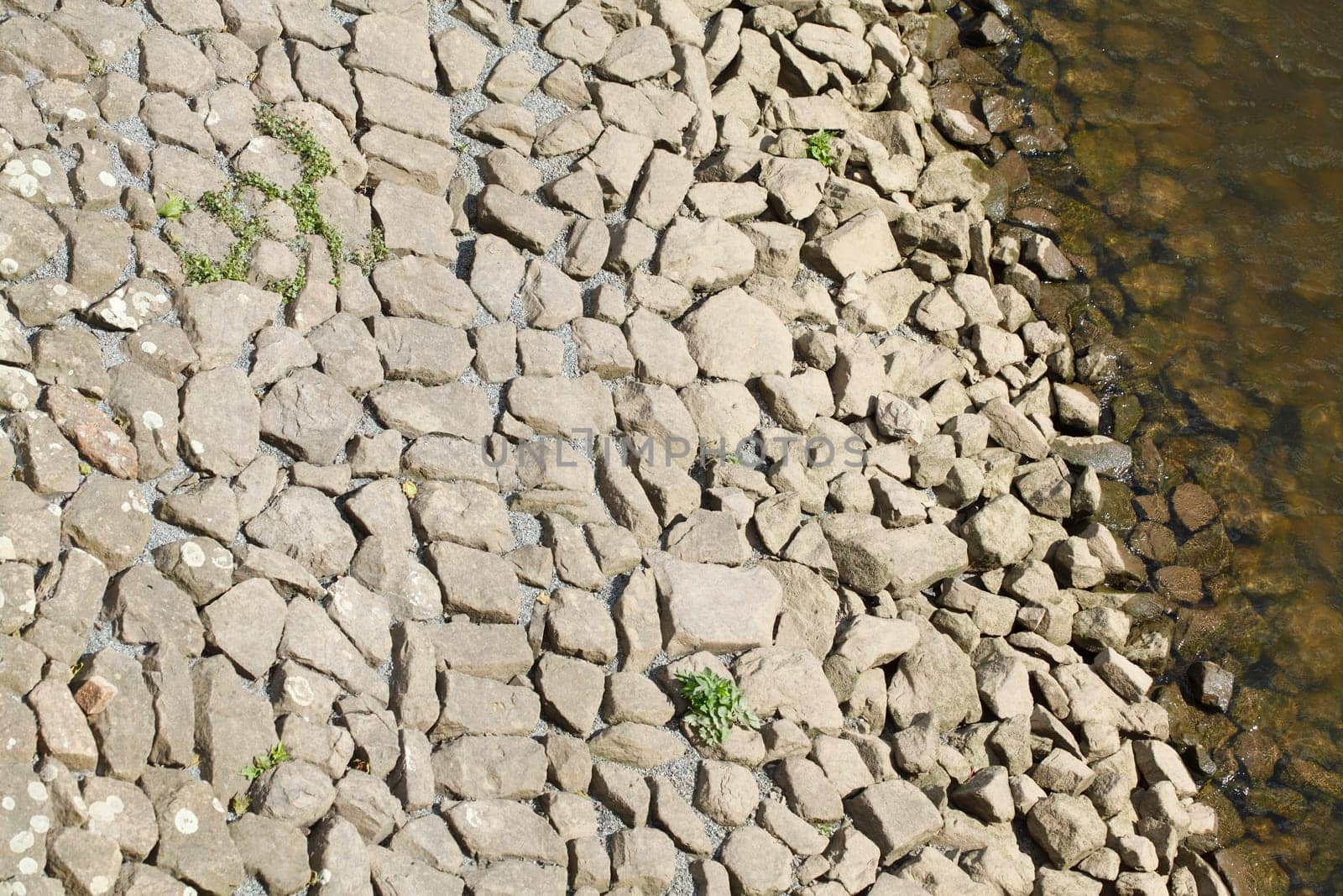 Stones at a shore embankment, background image