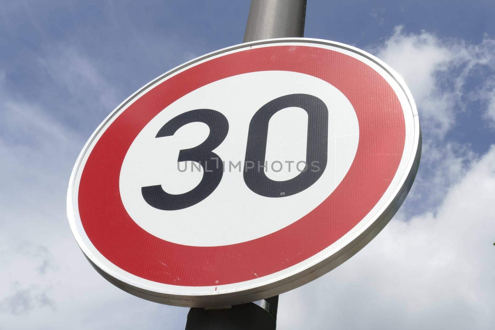 Road sign Maximum Speed ​​30 km / h, Blue sky with clouds
