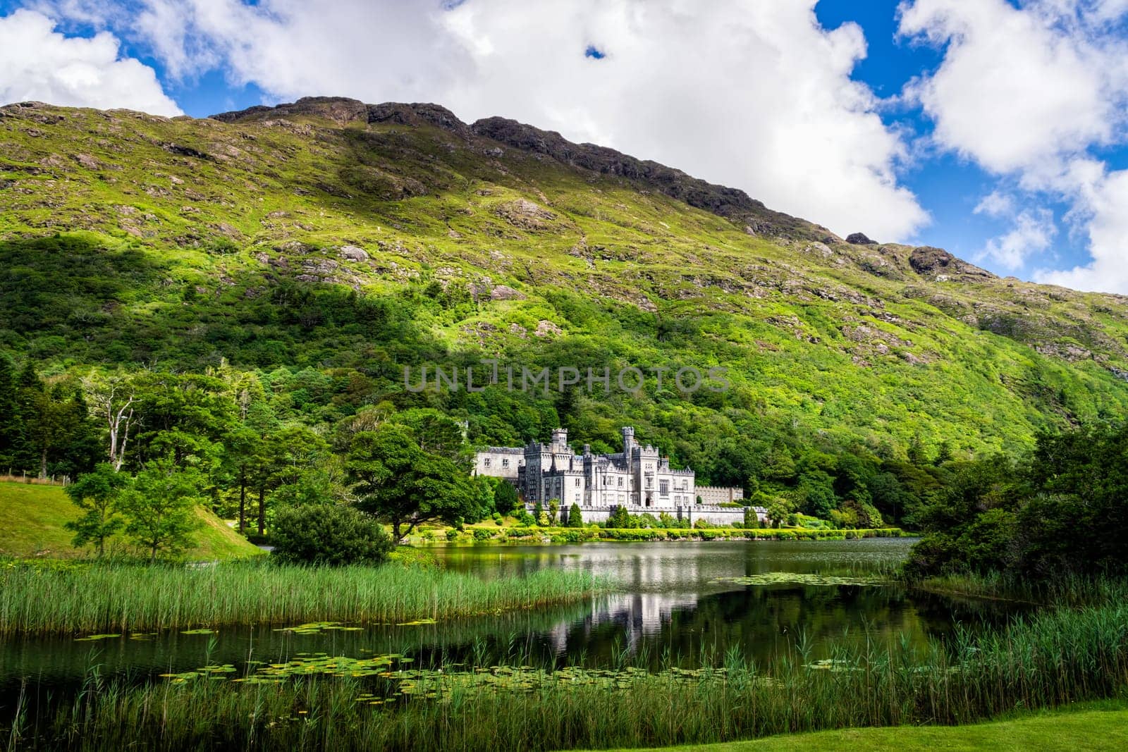Kylemore Abbey, beautiful castle like abbey with reflection in lake at the foot of a mountain. It is a Benedictine monastery founded in 1920, in Connemara, Ireland