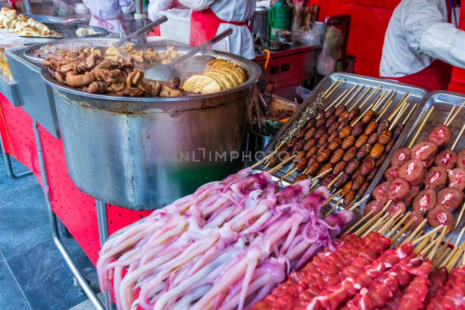 Roasted, fried and raw insects, silkworms, scorpions, bugs, snakes, dog meat, octopus on stick as snack street food in China