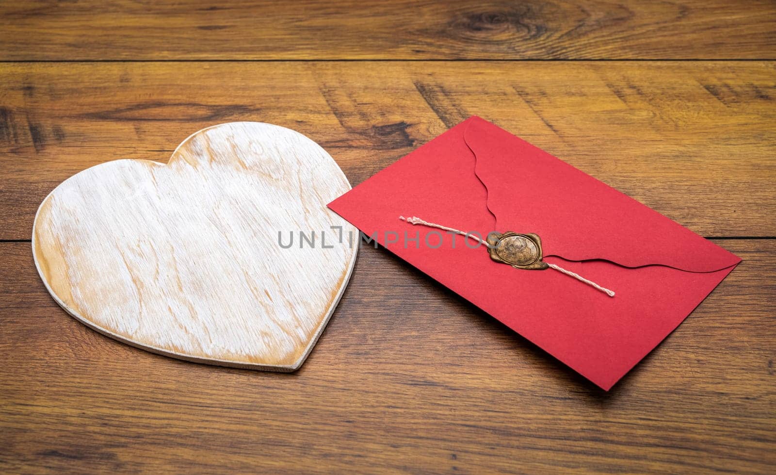 Retro classic Valentines Day cad, large white painted wooden hart, isolated, red envelope with wax seal, on vintage oak panels, front view