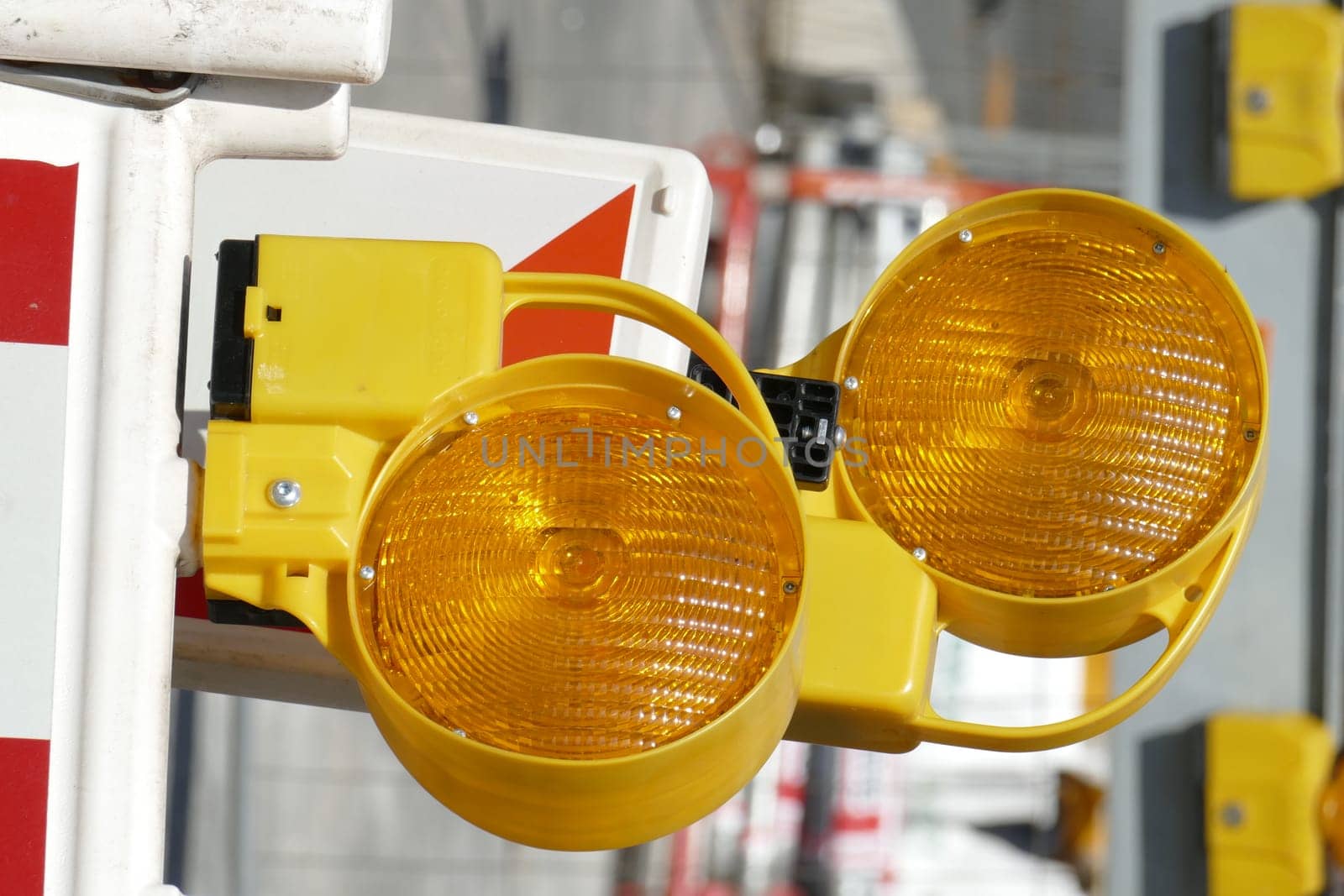 Orange construction site lamps at a construction site barrier, Germany, Europe