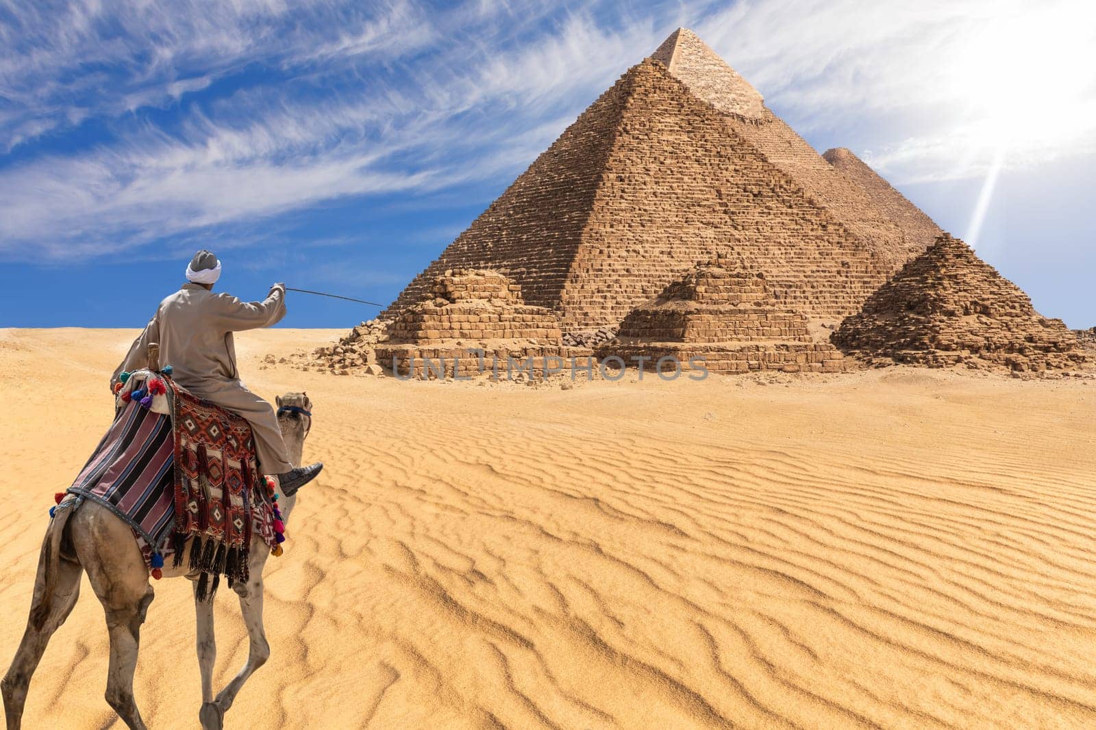 A bedouin of Giza desert in front of the Great Pyramids, Egypt.