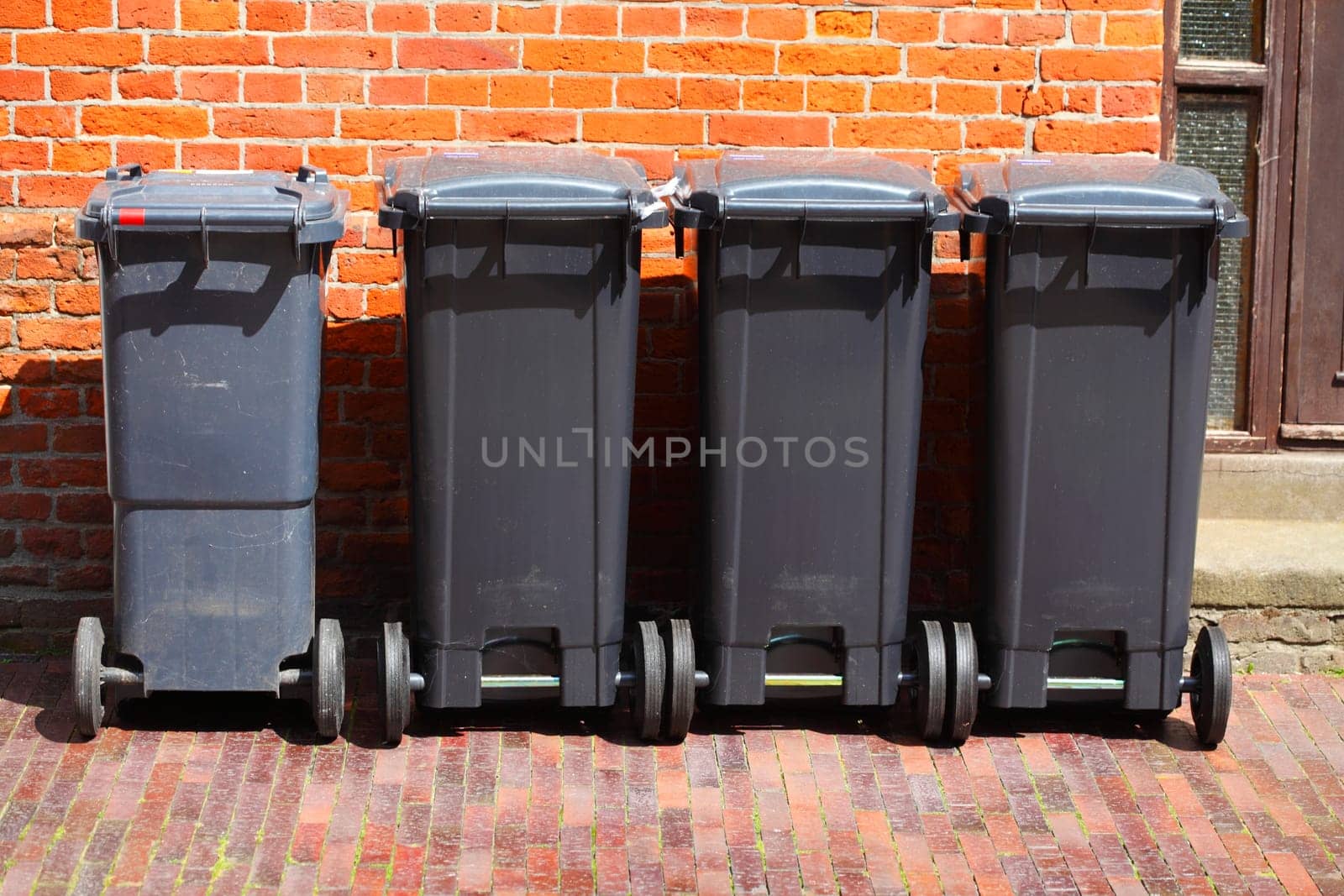 Recycling bins, rubbish bins for residual waste standing on the sidewalk, Germany, Europe