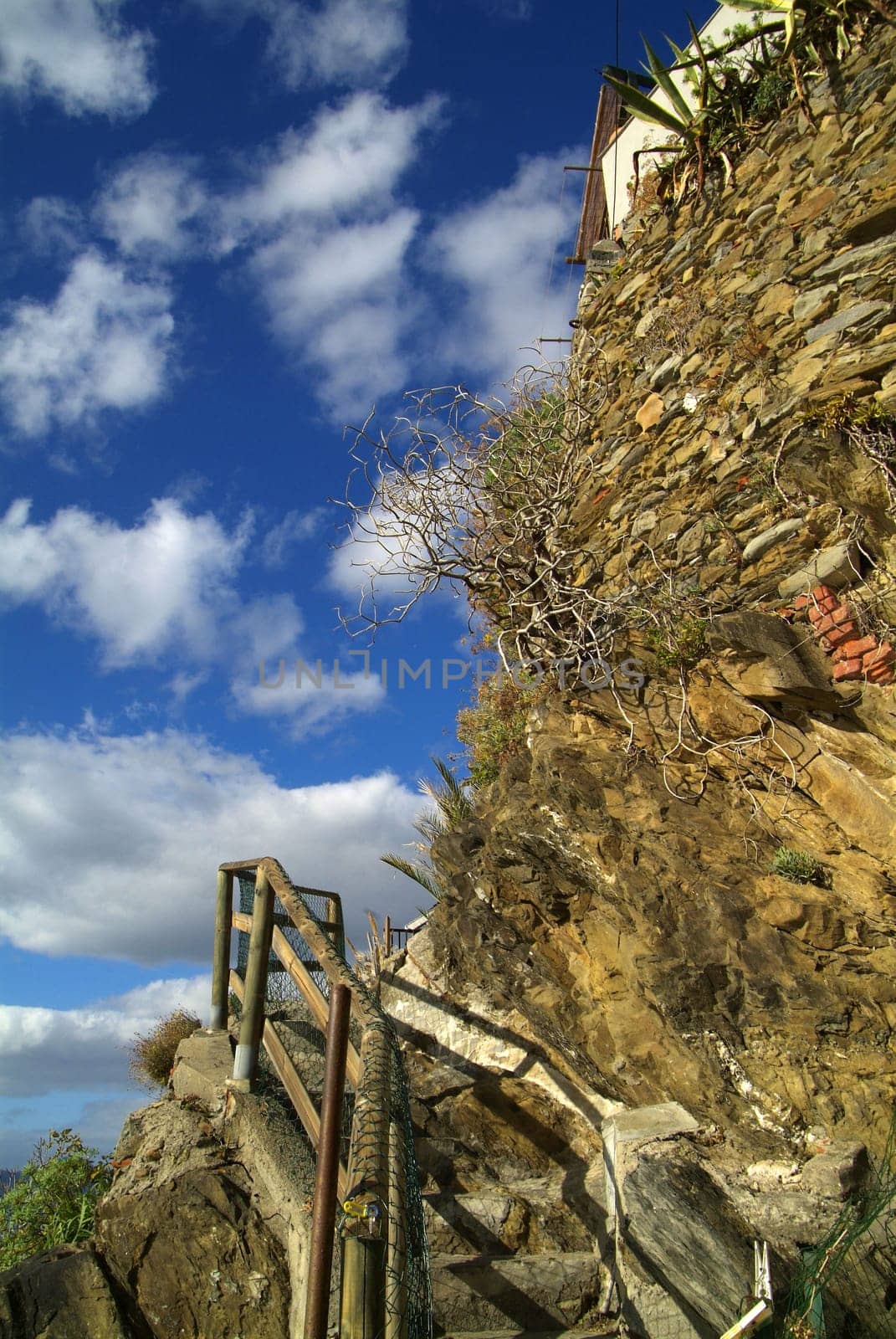 Cinque Terre, Italy - Nov 11, 2006: Buildings in the city of Riomaggiore. It is one of the five famous colorful villages of the Cinque Terre National Park in Italy. With the sky covered by nub that obscures the path of love.