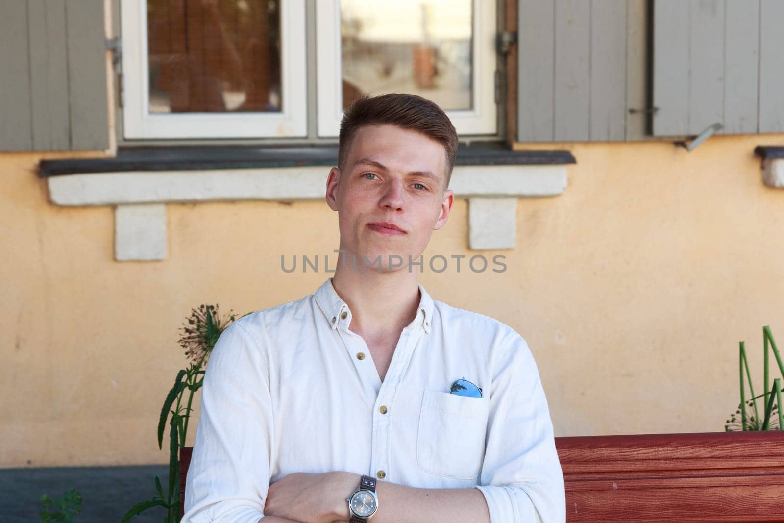 Young man sitting on bench in outdoors