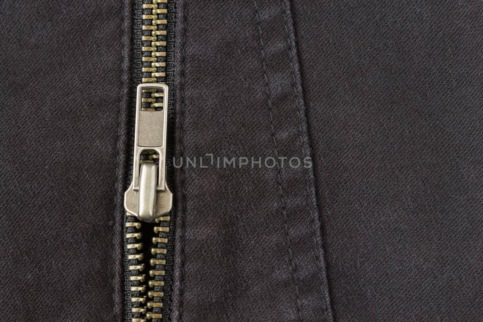 Open Brass Zip on Black Jeans Texture Background. Open Brass Zip on Black Jeans Texture Background for Apparel Design