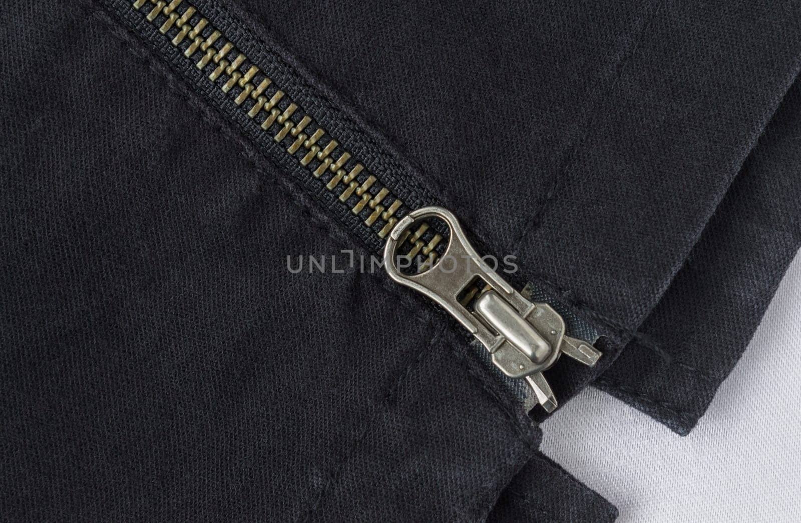 End of Closed Brass Zip on Black Jeans Texture Background. Closed Brass Zip on Black Jeans Texture Background for Apparel Design