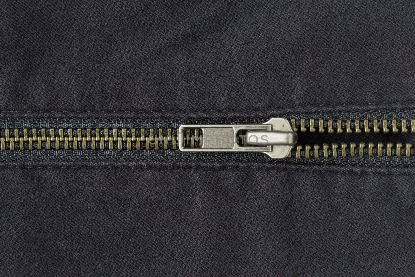 Open Half Brass Zip on Black Jeans Texture Background. Open Brass Zip on Black Jeans Texture Background for Apparel Design