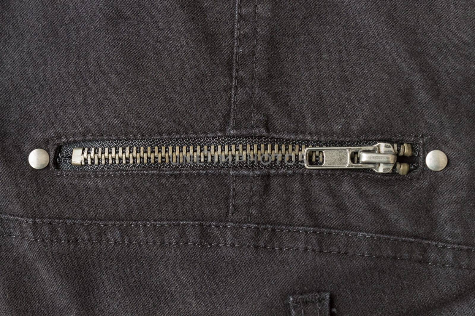 Closed Brass Zip on Black Jeans Texture Background. Closed Brass Zip on Black Jeans Texture Background for Apparel Design