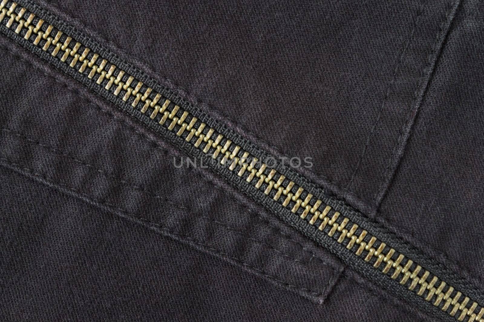 Brass Zip on Black Jeans Texture Background. Closed Brass Zip on Black Jeans Texture Background for Apparel Design