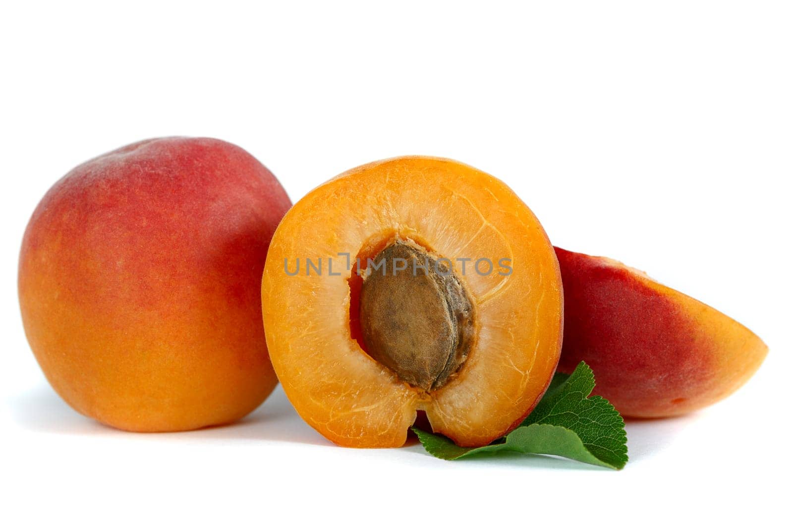 Ripe yellow-red apricots, half with bone and whole in cut close-up