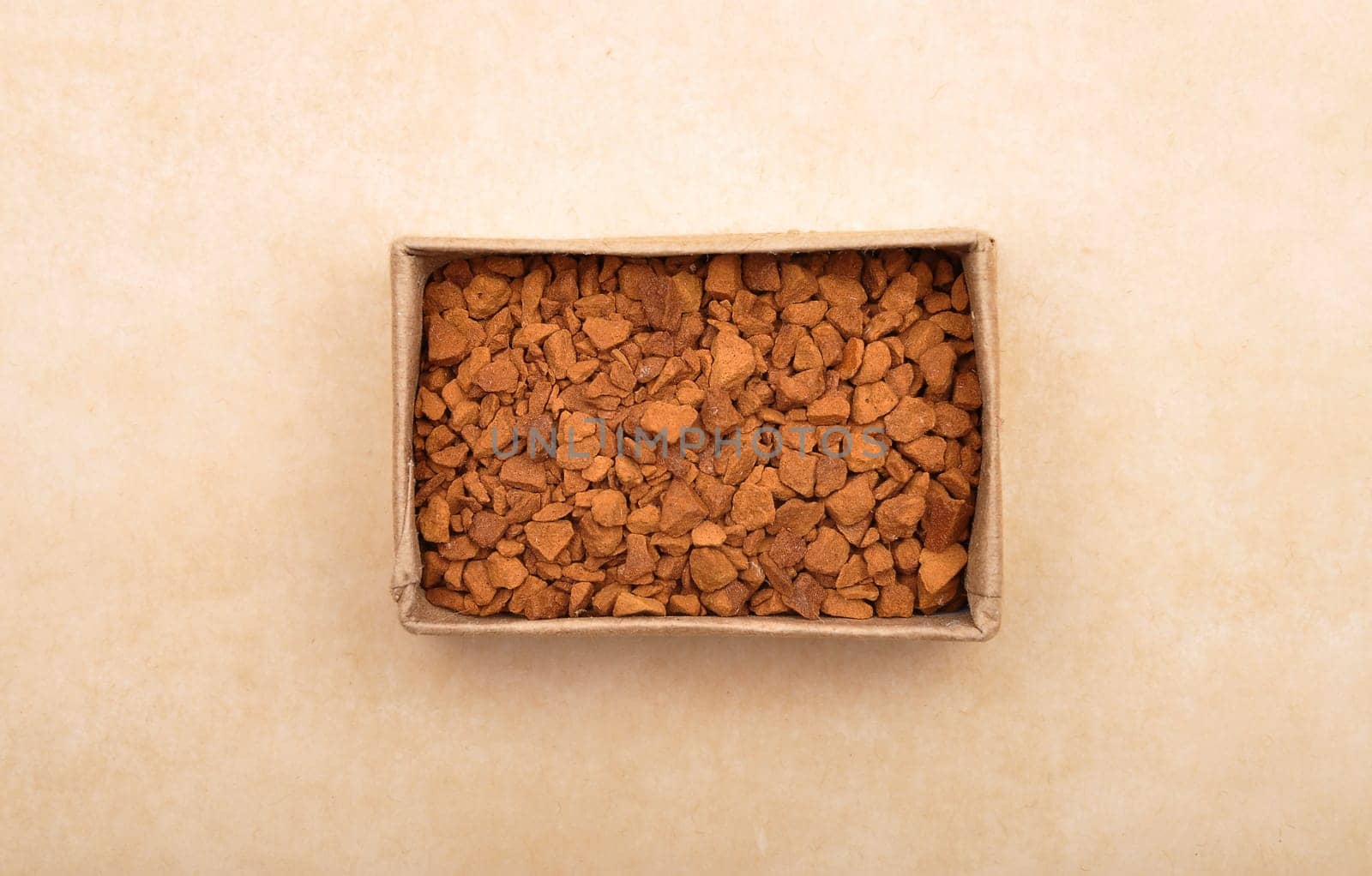 Instant Coffee in paper box on brown background