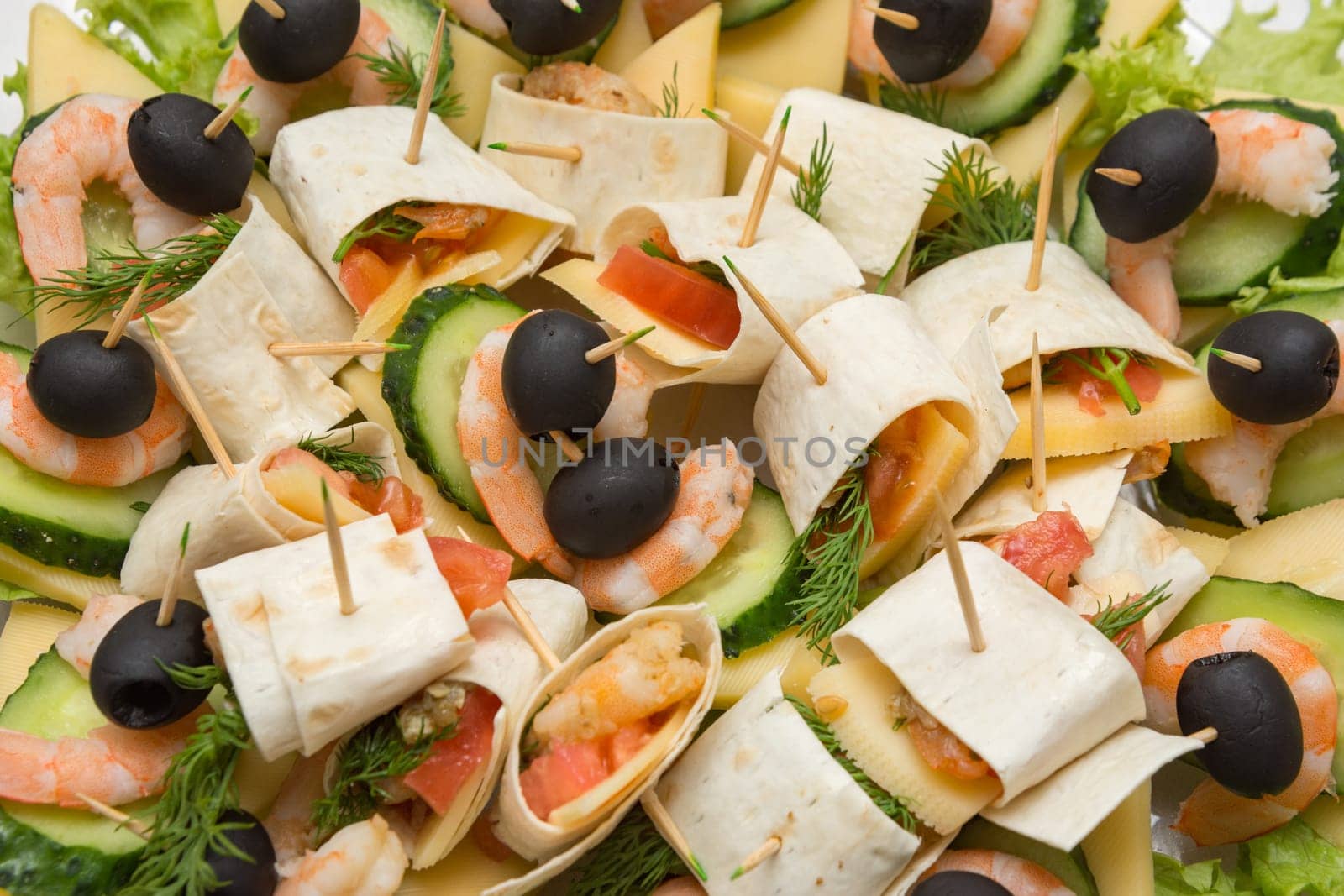 Konope snack on skewers, salad, cheese, shrimp and olive