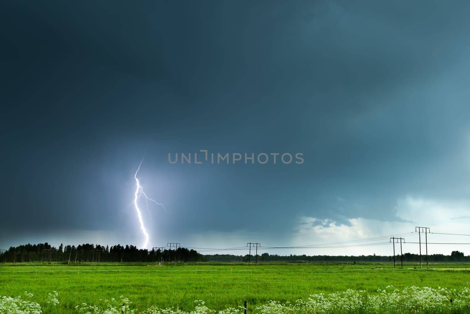 Lightning over Agricultural Field with a cloudy sky.