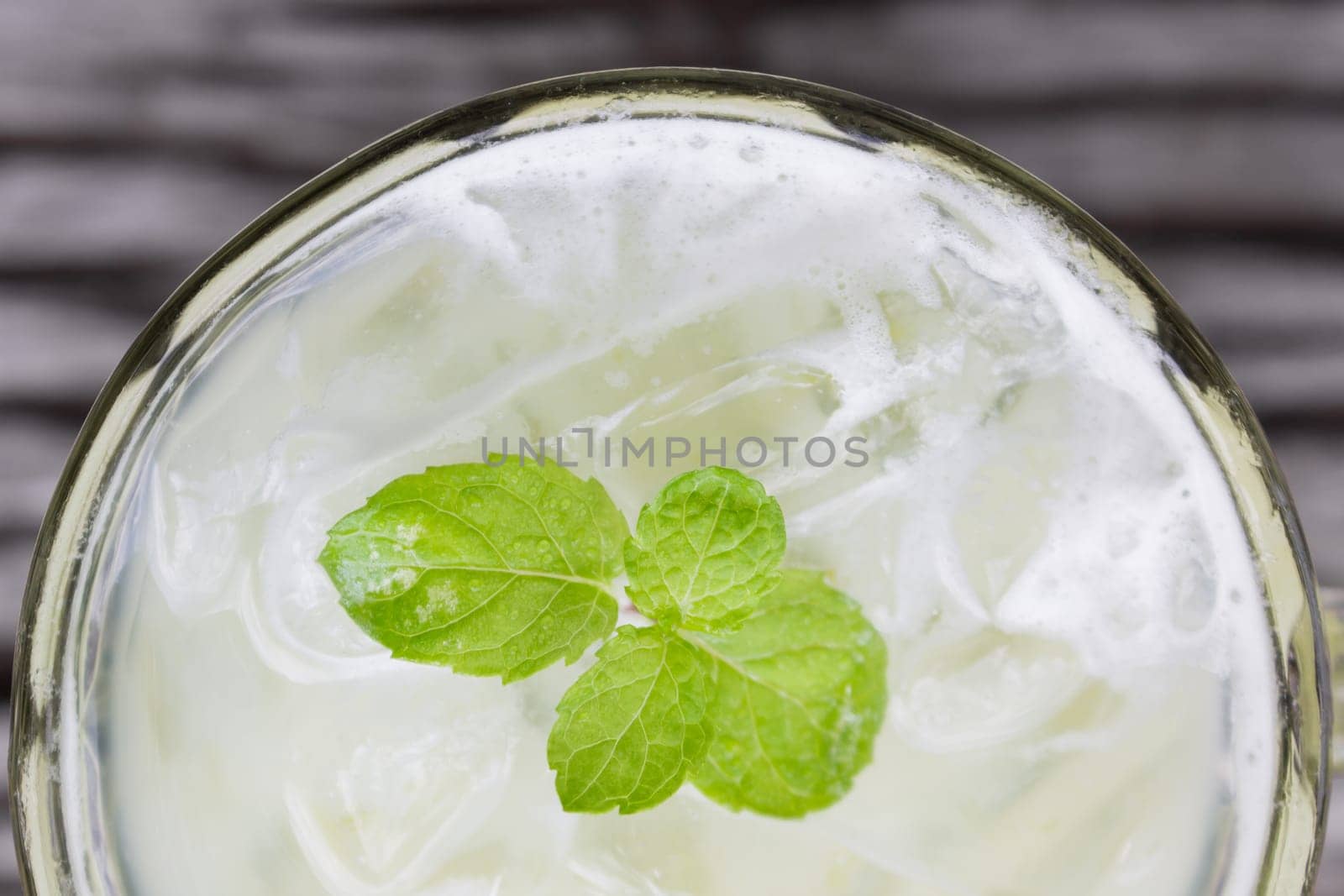Cold Green Tea Milk Beverage or Cold Drinks Flatlay Bottom Frame. Green cold drinks and ice on wood table for drink