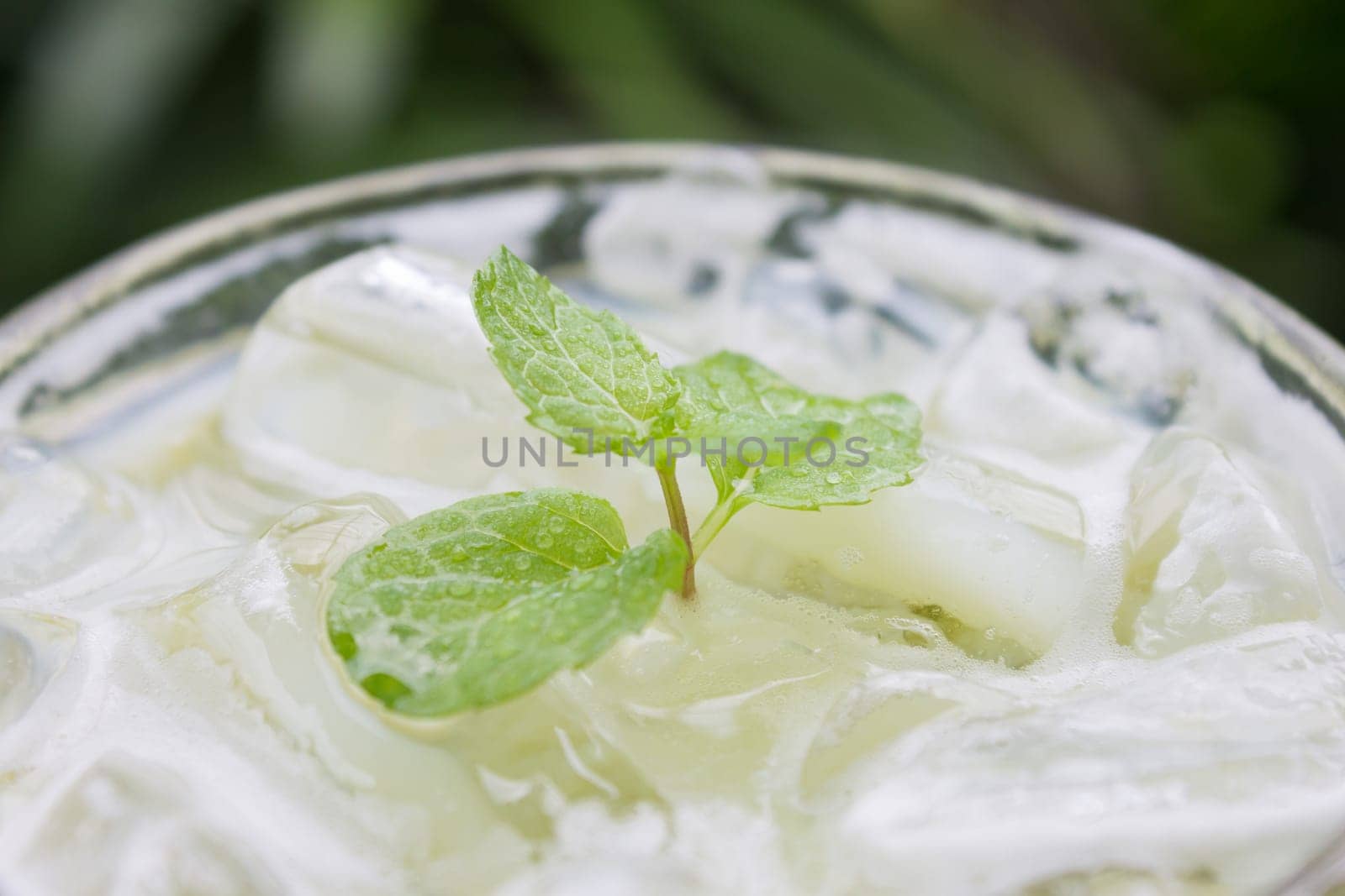 Cold Green Tea Milk Beverage or Cold Drinks Close-Up View. Green cold drinks and ice on wood table for drink