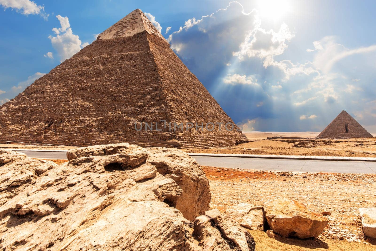The Pyramid of Chephren, the Pyramid of Menkaure, view from the road in the desert.
