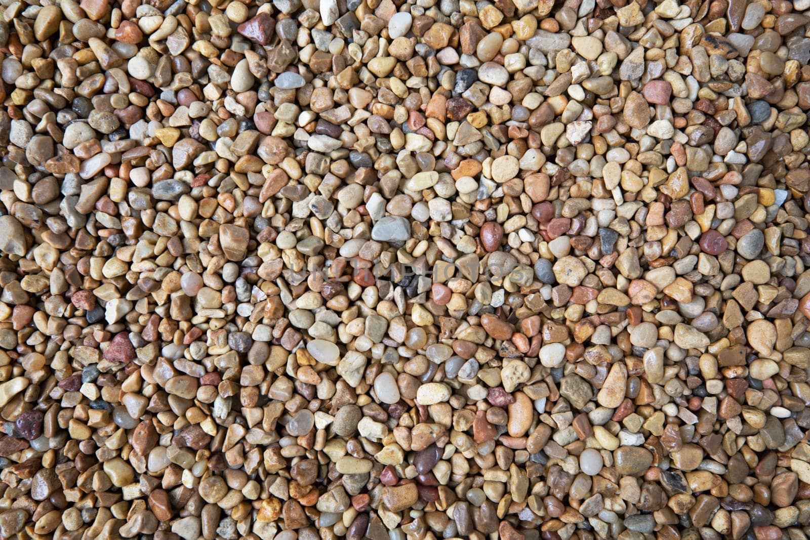 Brown white and blue pebble texture with various sizes.