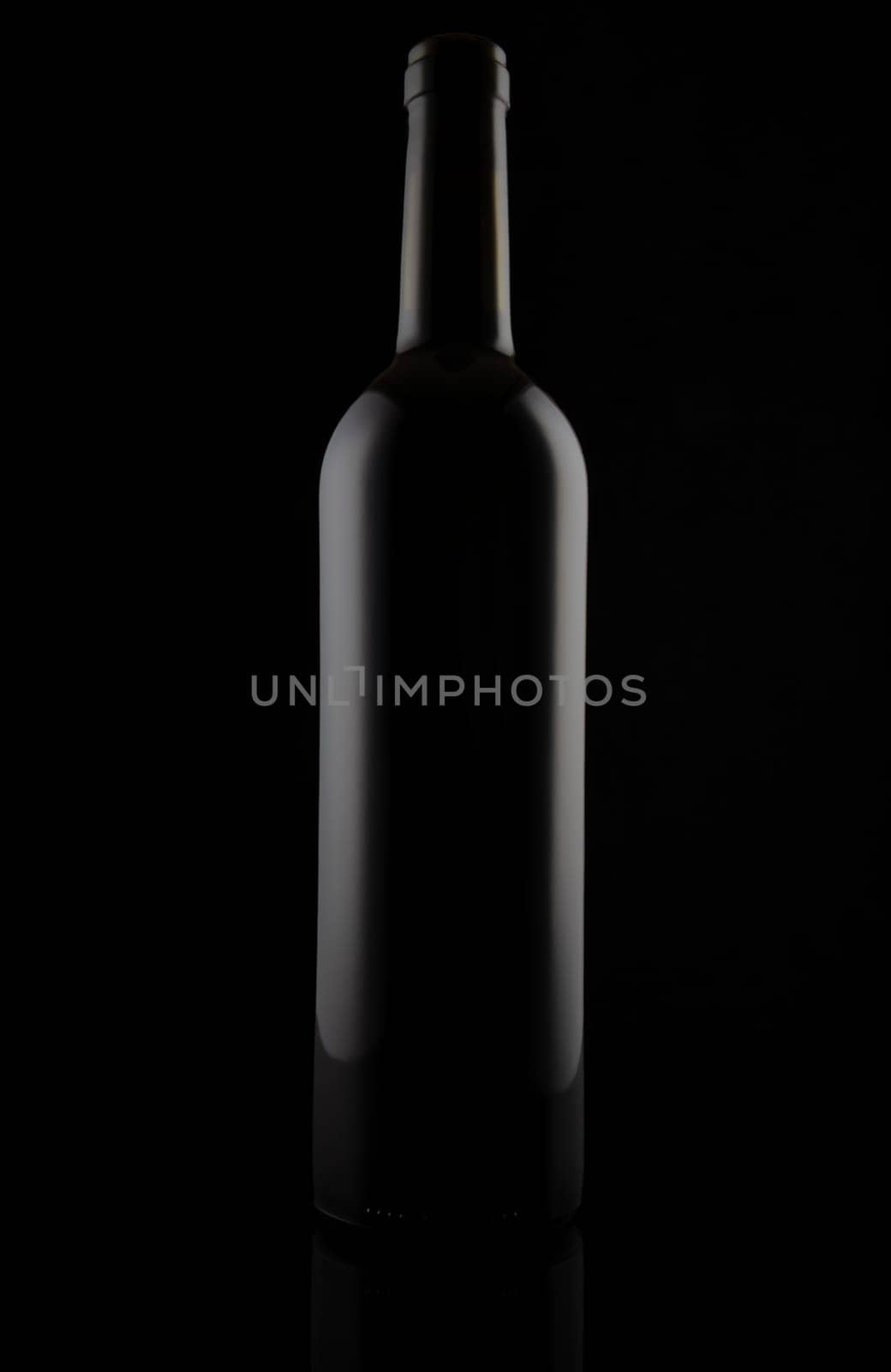 Black matt glass wine bottle, isolated on black.