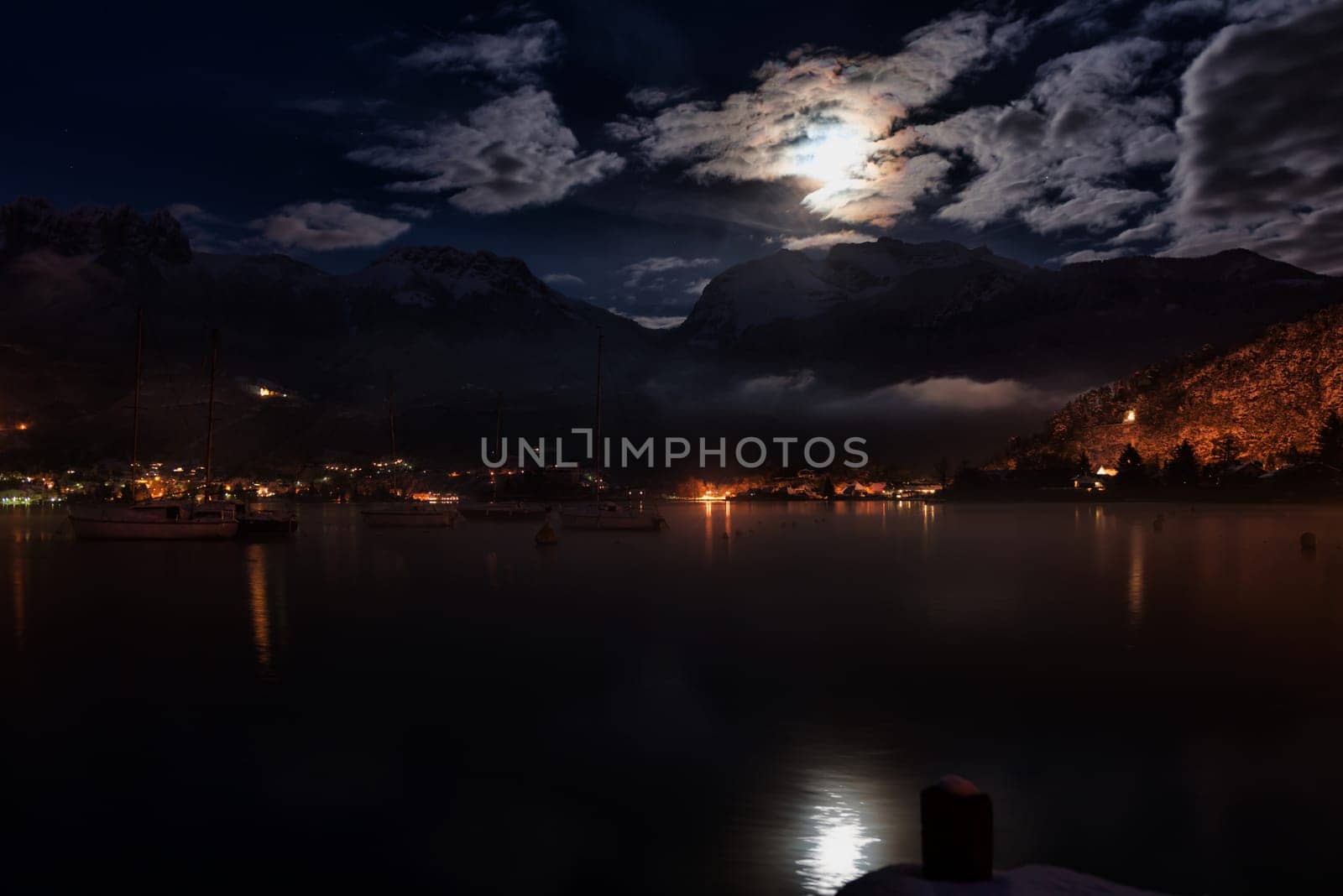 lake and mountain night with some boats