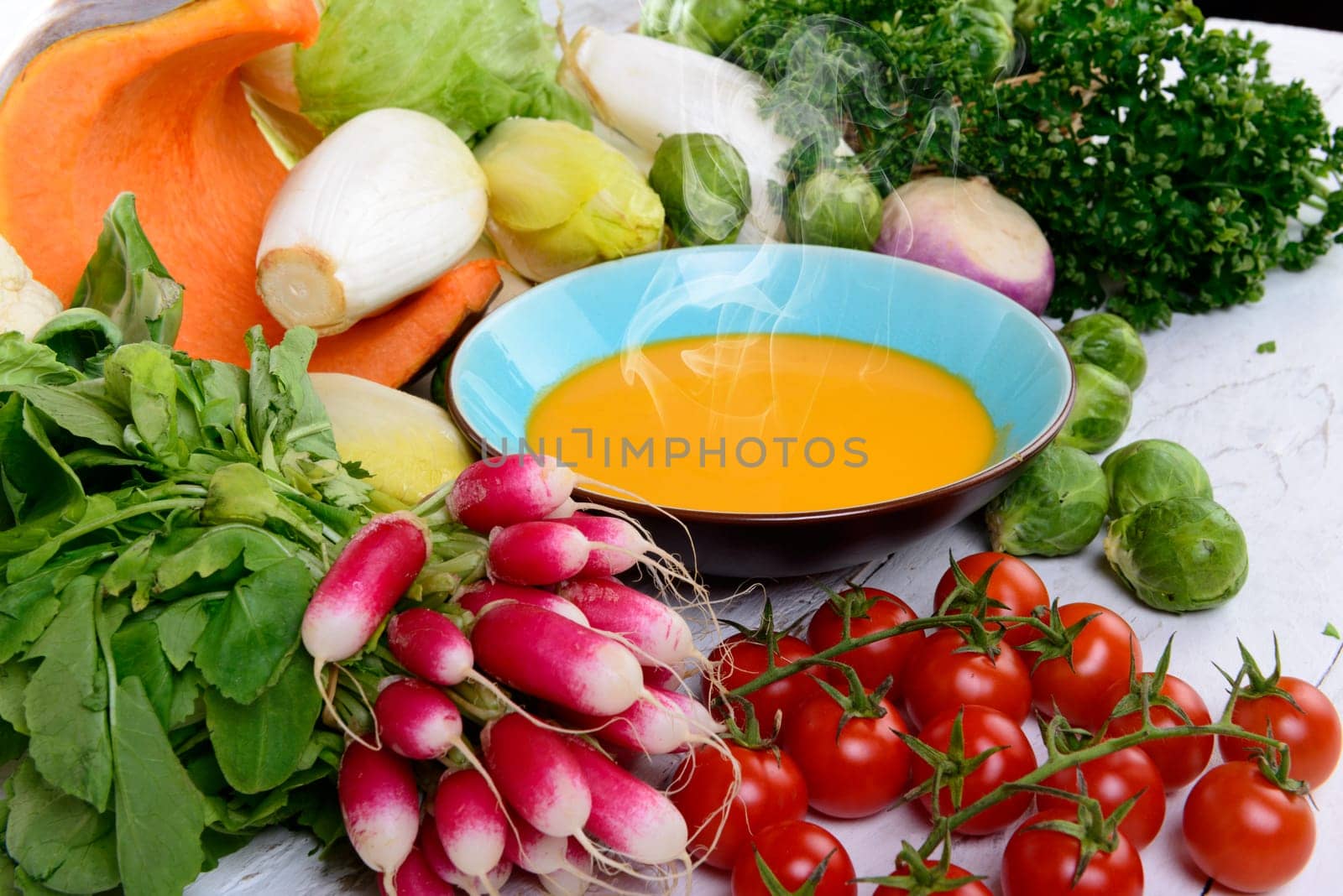 plate of pumpkin soup with  several vegetables
