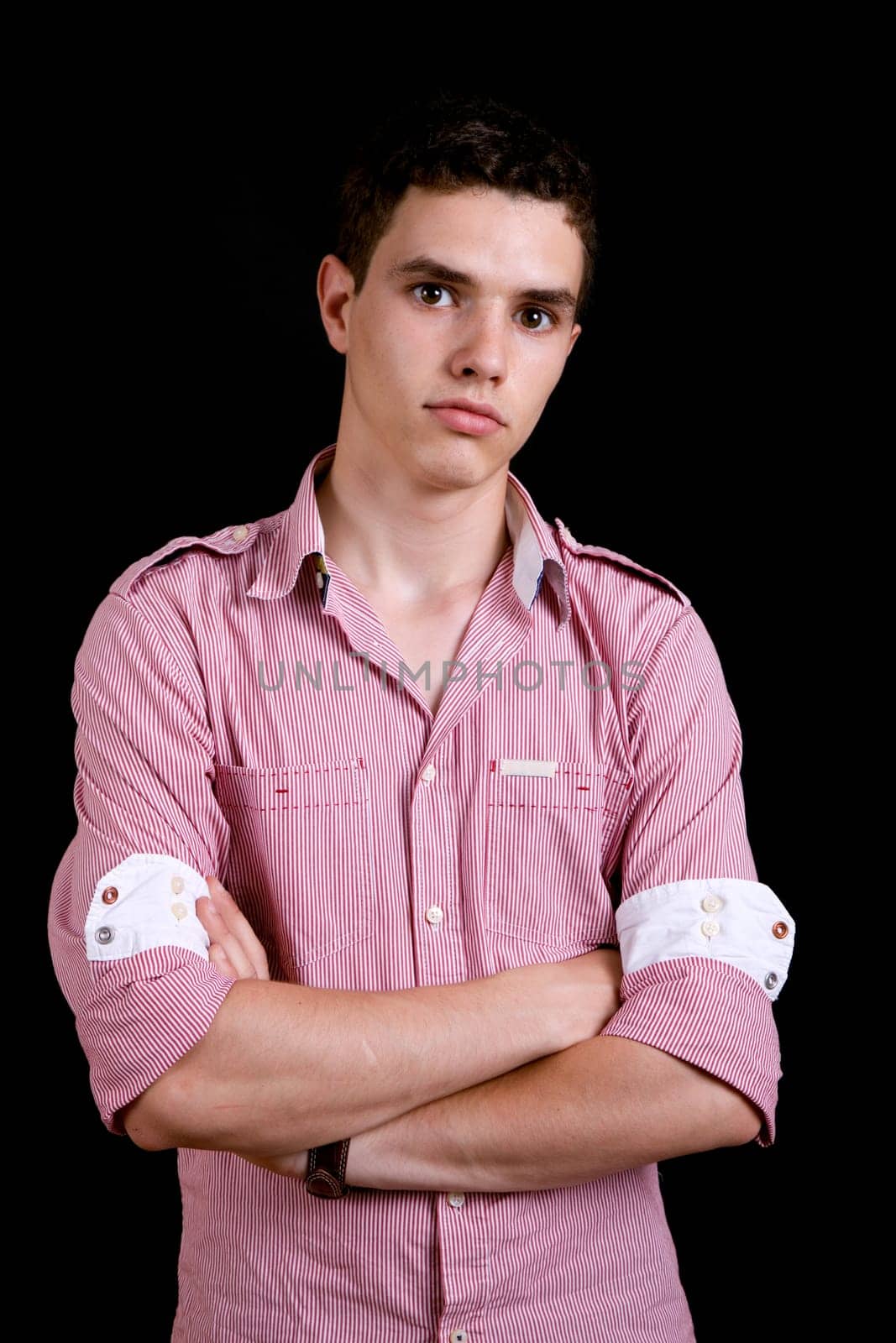 young casual man against a black background