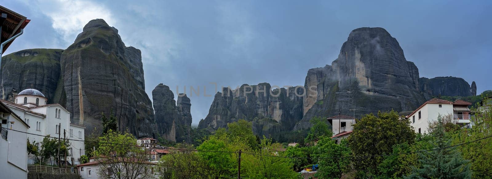 Panoramic view of the impressive rock formations and landscape as seen in the small Kastraki settlement in Meteora at dusk, Trikala region, Greece