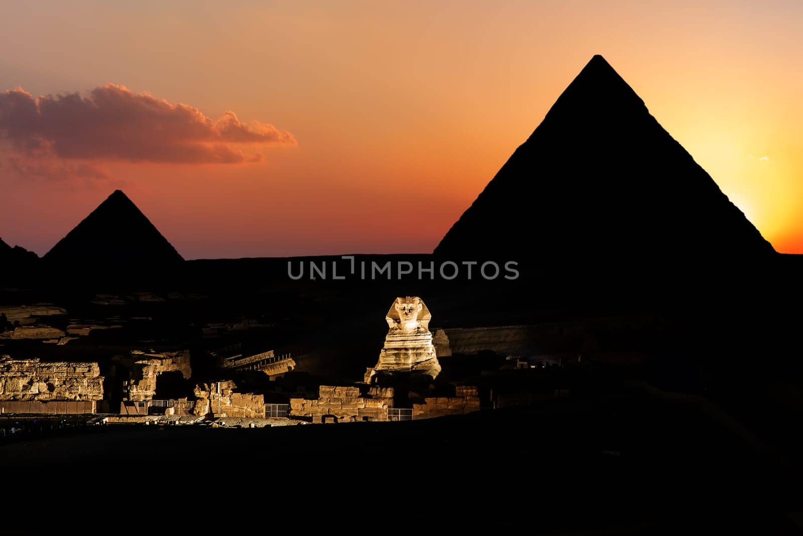 Pyramids and the Sphinx in twilight in Giza, Egypt.
