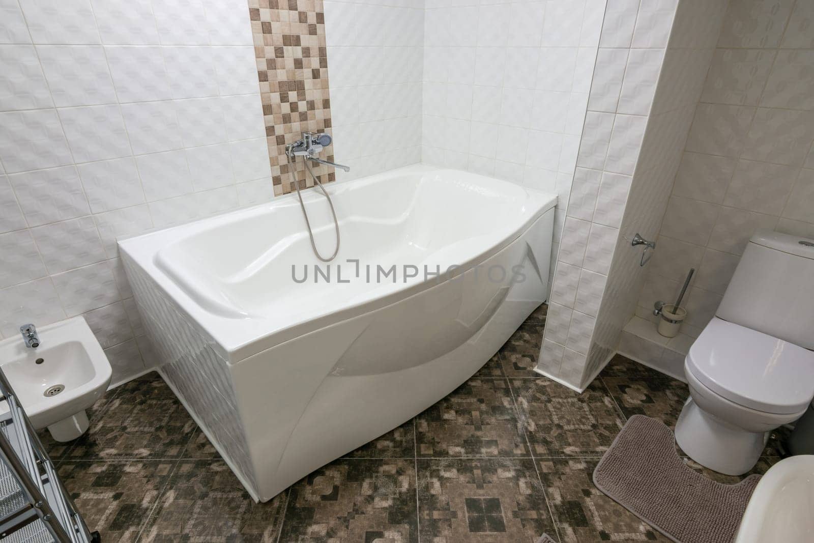 Interior of a large bathroom combined with a toilet