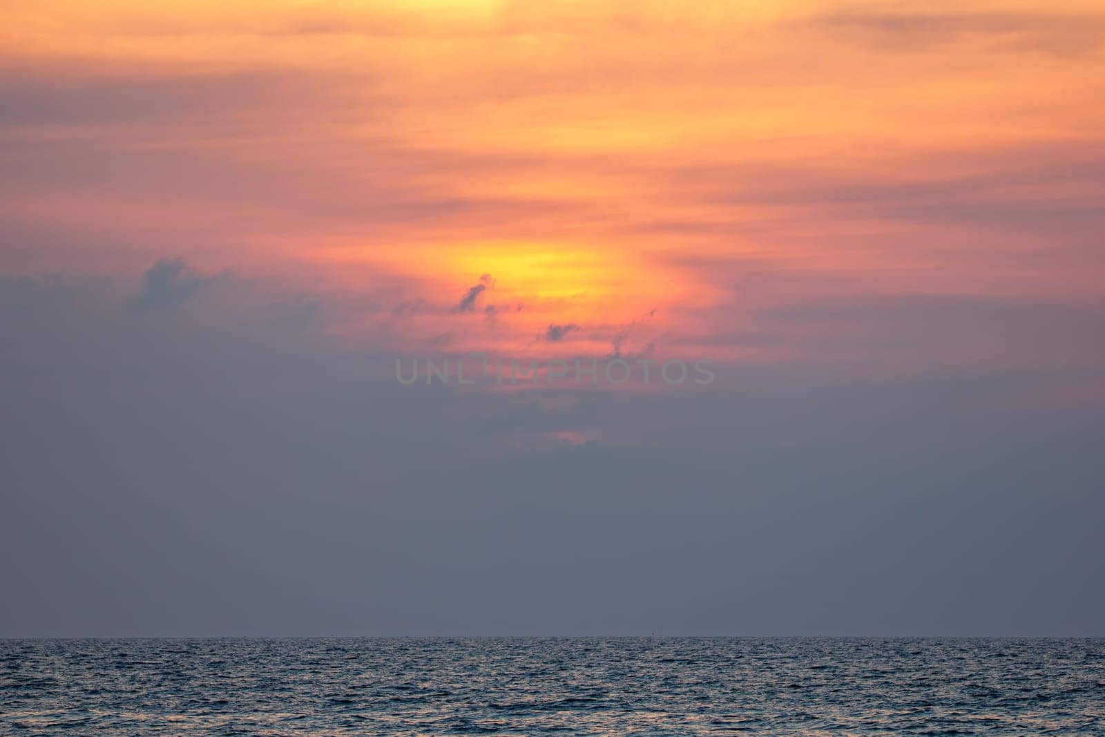 Sunset, sunlight through the clouds Born orange across the sky Orange reflective sea