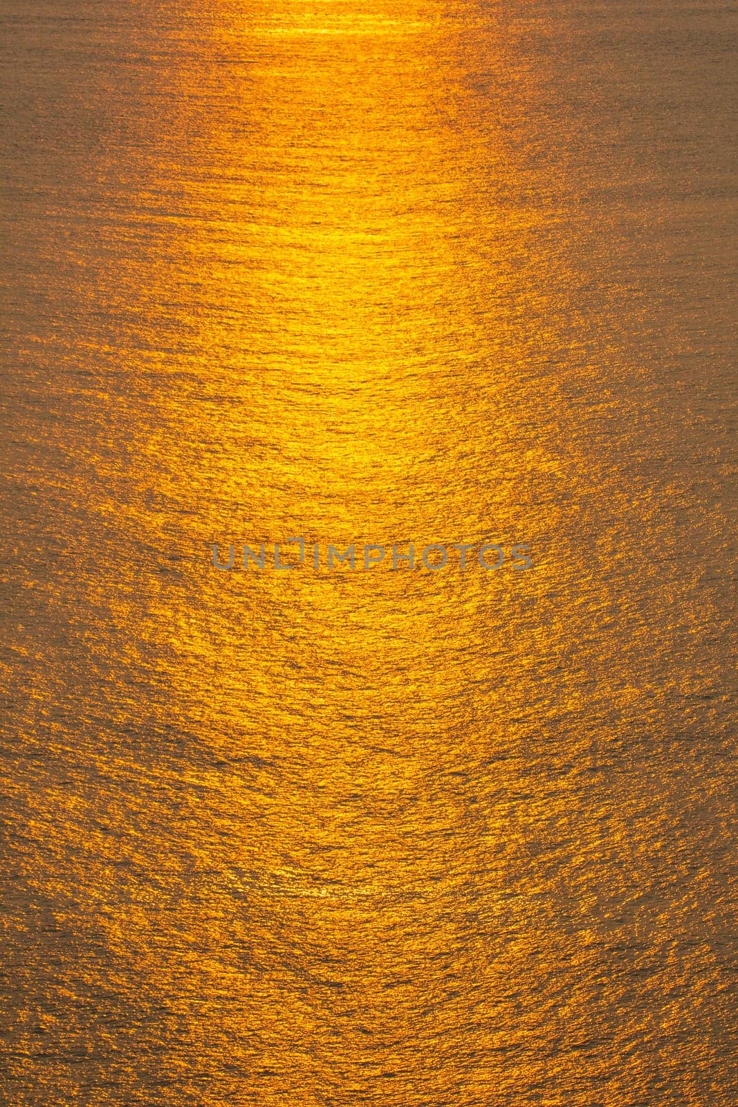 Sunset The sea surface reflects the sunlight in gold.