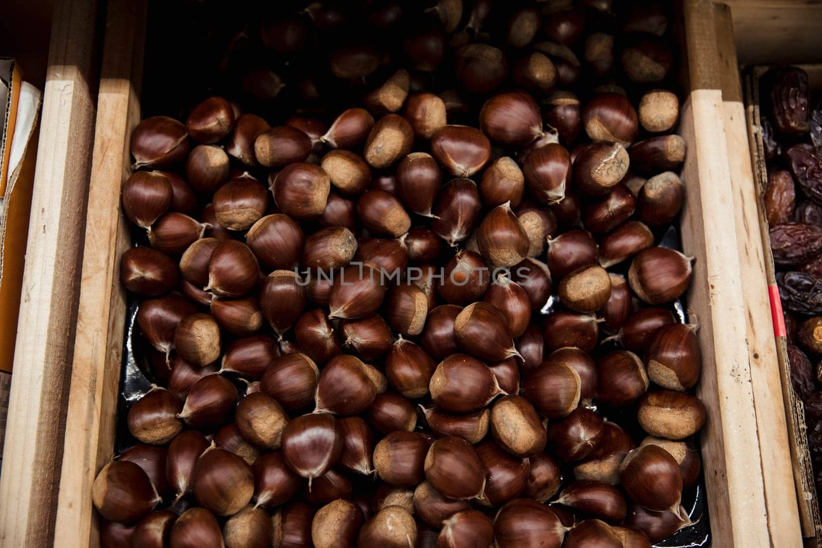 A close-up shot of an abundance of fresh Hazelnuts on display at a market stall.
