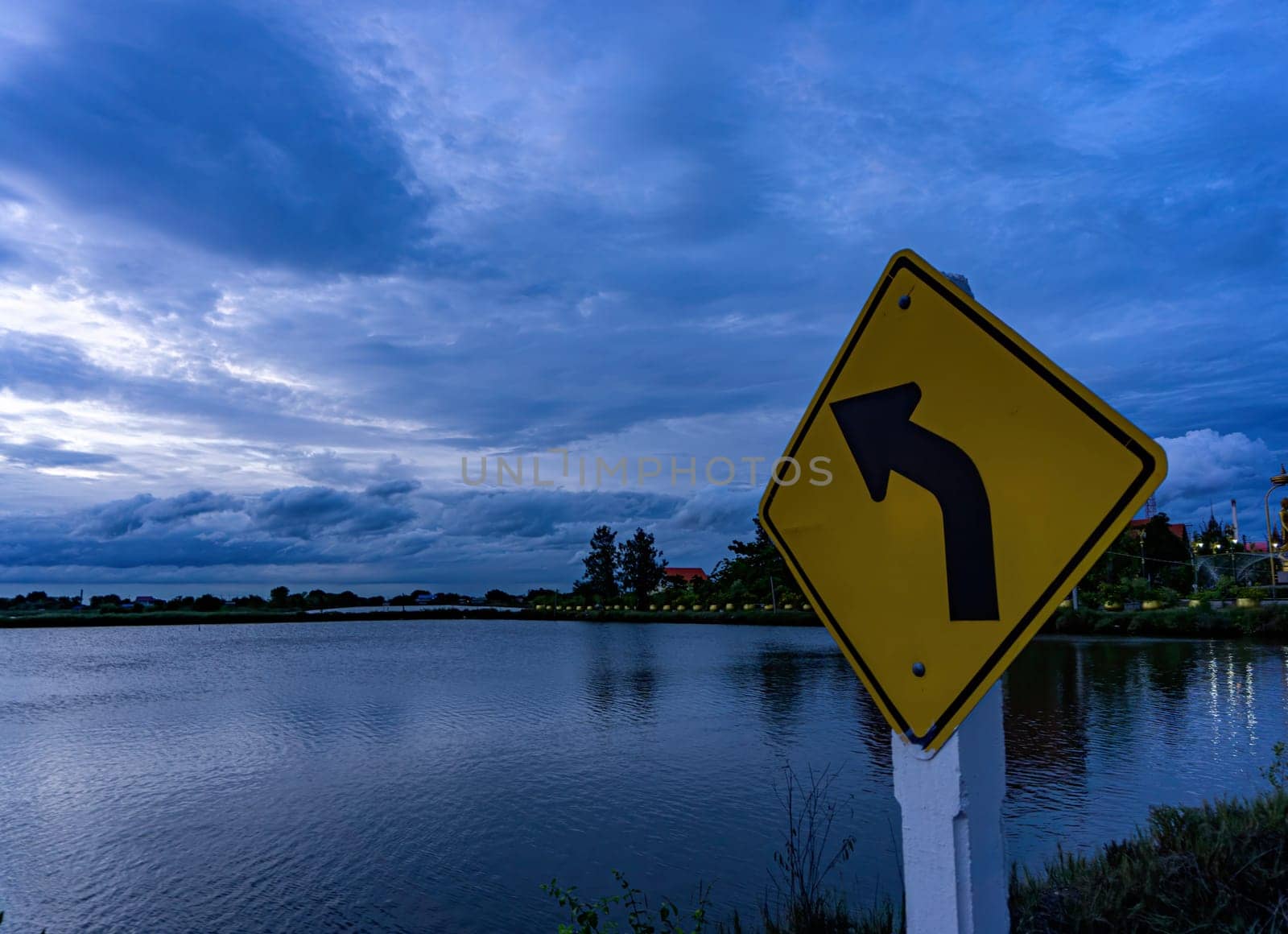 The signs on the left curve point towards the clouds..The sky after the sunset