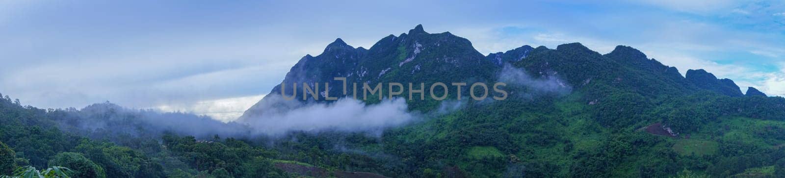 Green Mountain Panorama. There is a fog in the middle of the mountain and at the top of the mountain