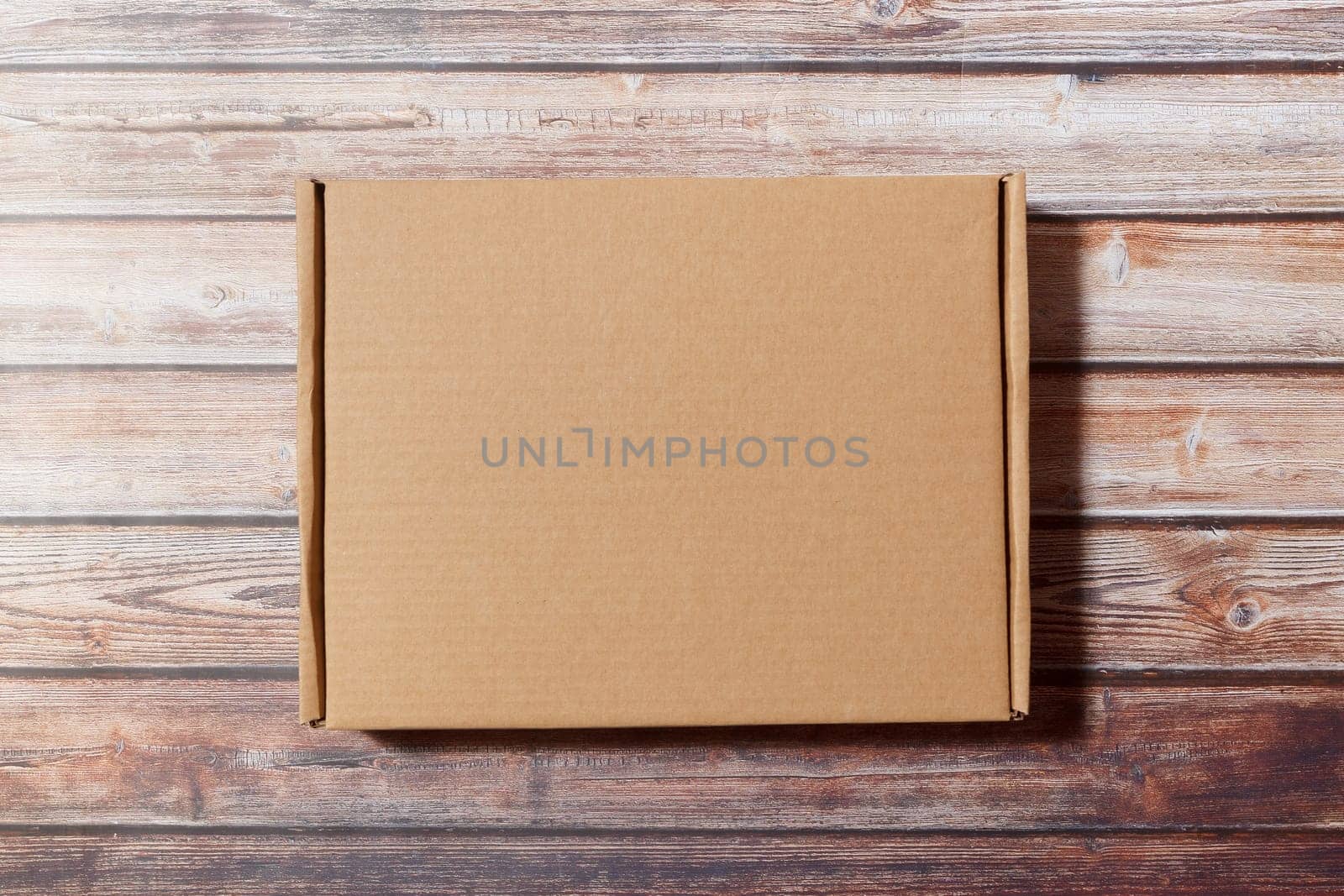 Simple Cardboard box on a wooden background