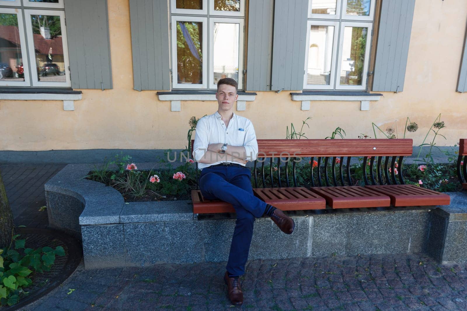 Young man sitting on bench in outdoors