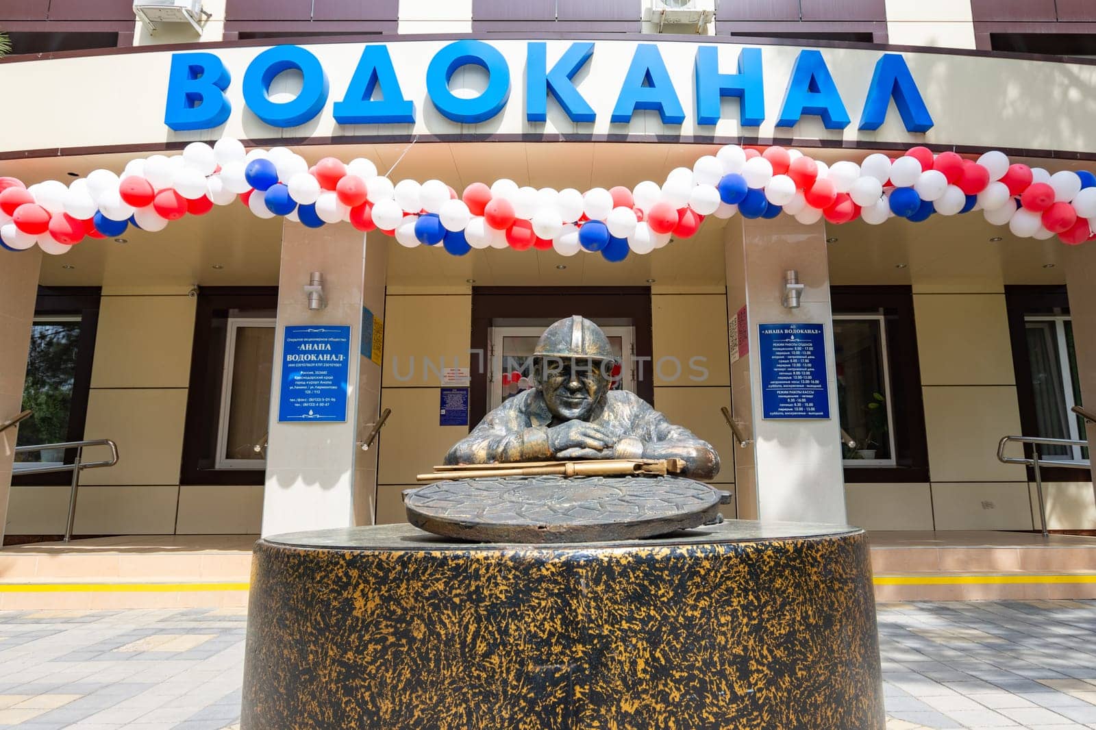 Anapa, Russia - May 1, 2019: Monument to the plumbing "Bronze Petrovich"" close up, at the central entrance of the water utility building in Anapa, Russia"