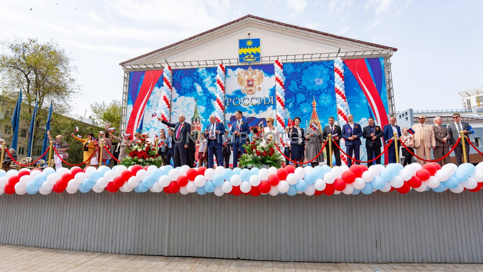 Anapa, Russia - May 1, 2019: High-ranking guests and the mayor on the stage greet the May Day demonstration on the Theater Square of the resort town of Anapa