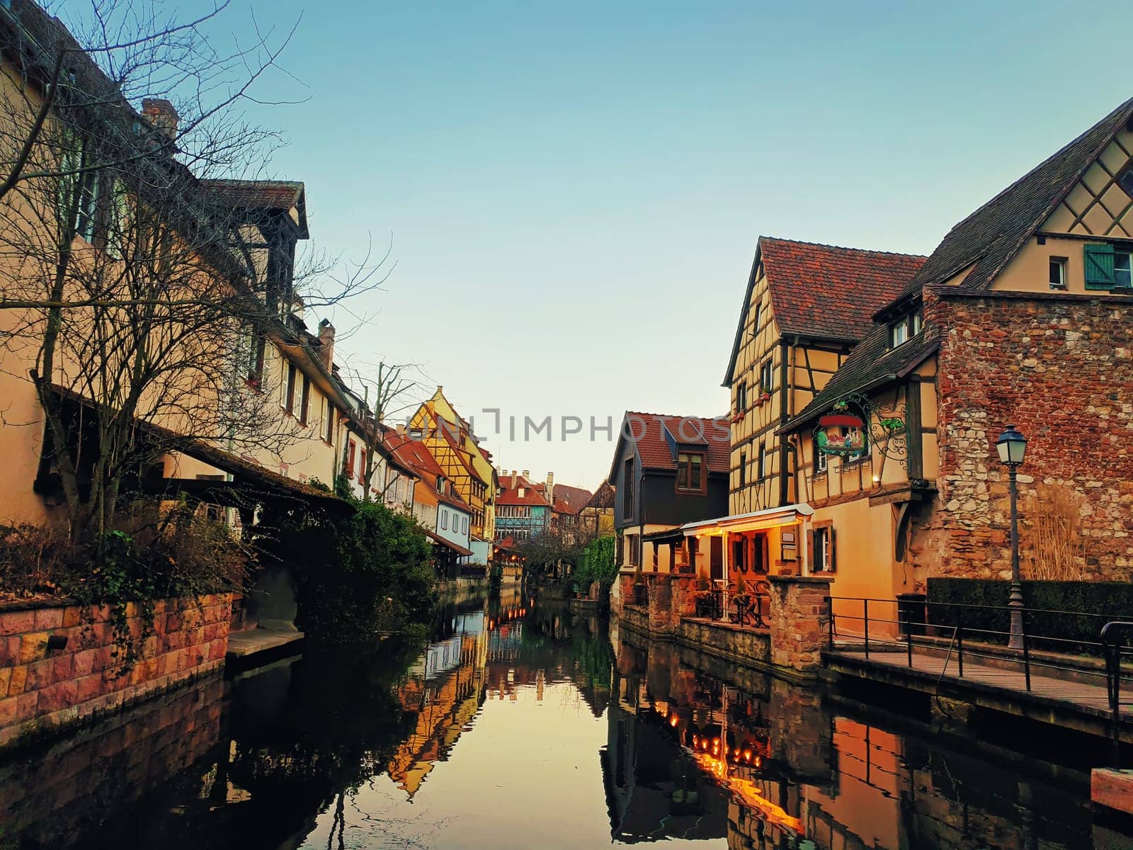 Autumn evening in colorful romantic city Colmar, France, Alsace. Traditional houses near the river. Medieval home facade, historic town. Beautiful idyllic architecture.
