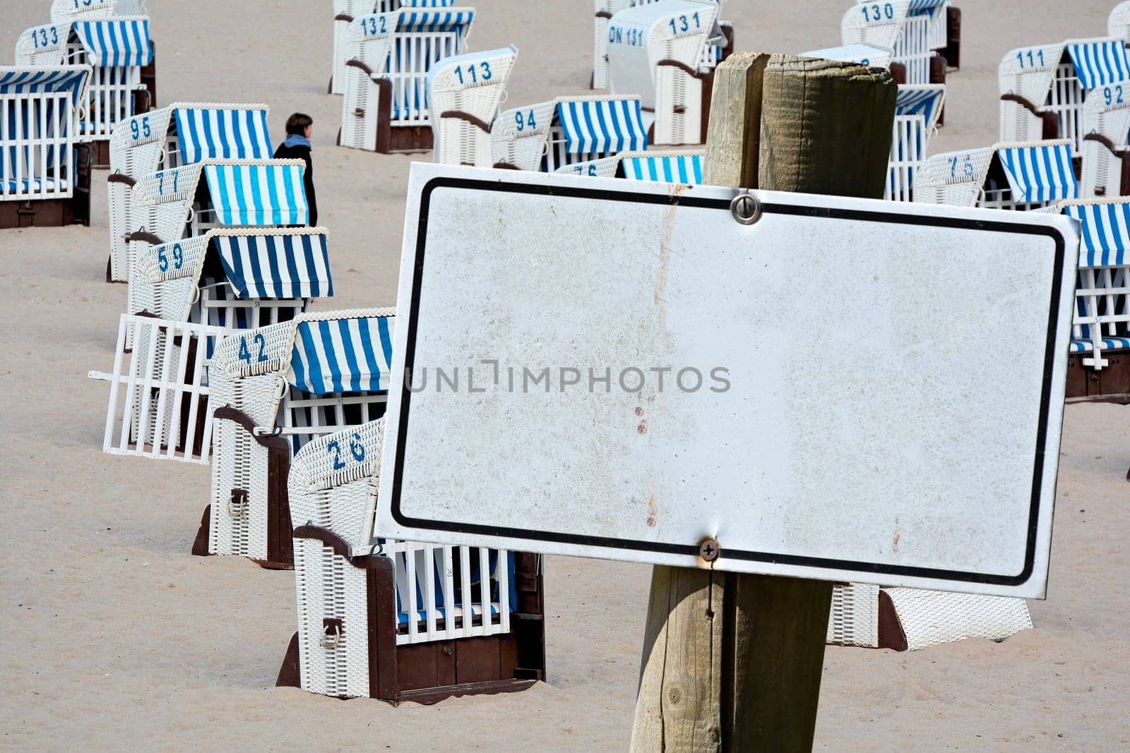 Empty signboard with copy space in front of beach chairs on the beach of the Baltic Sea in Germany