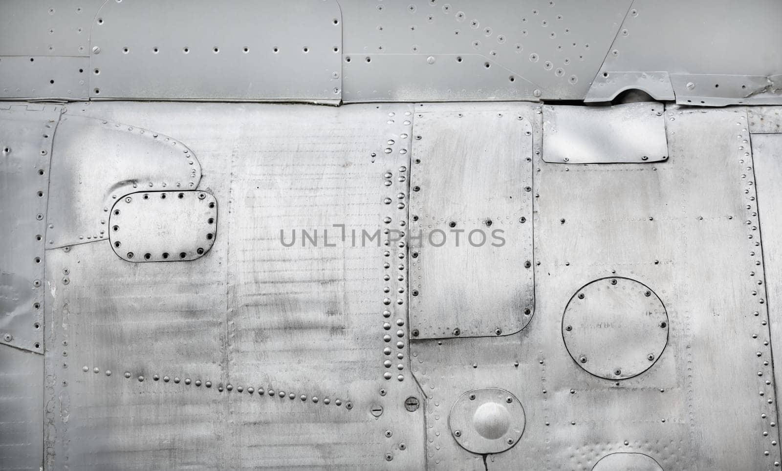 Old metal background. Weathered metallic texture with rivets and bolts.