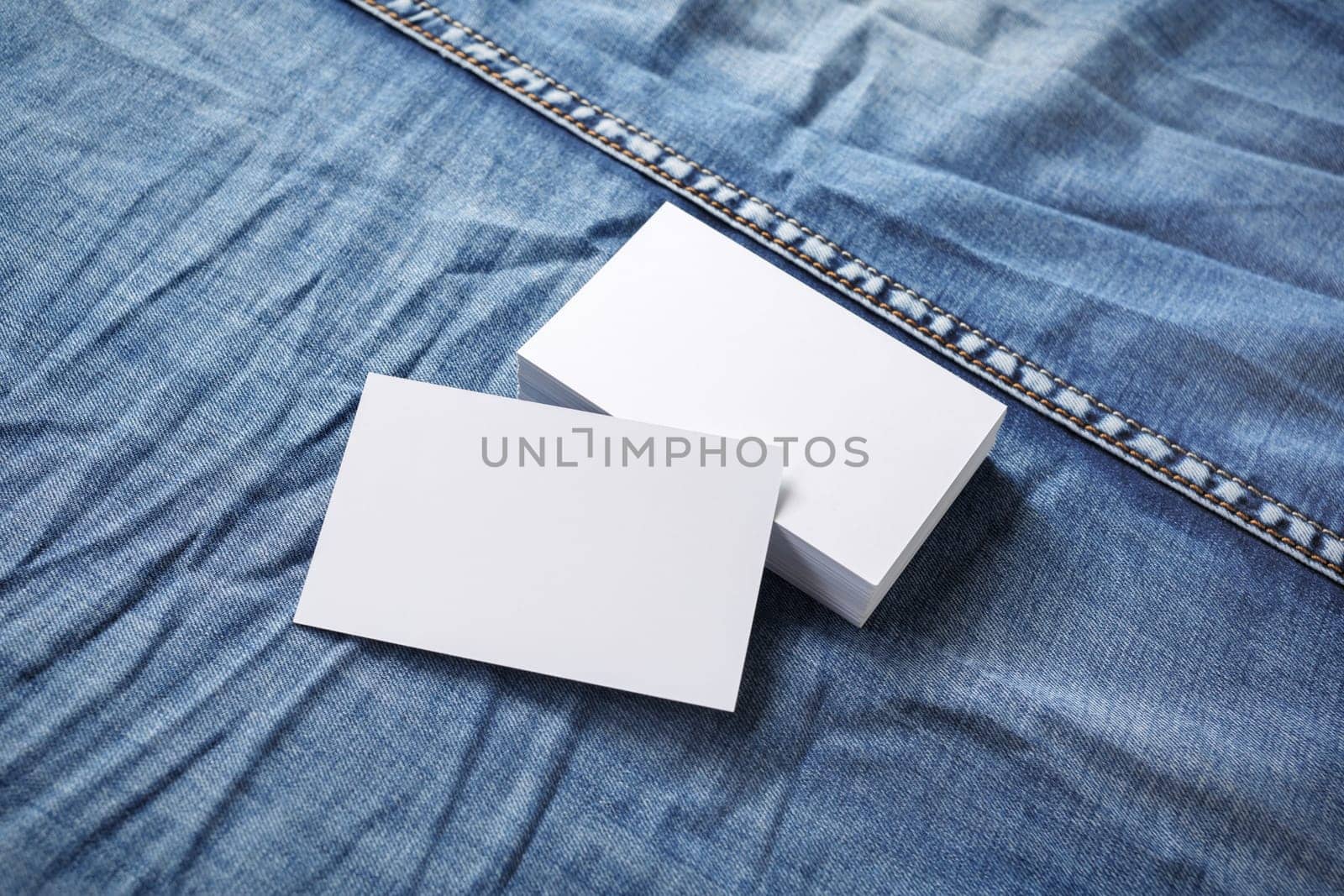 Blank business cards template on denim background. For graphic designers portfolios.