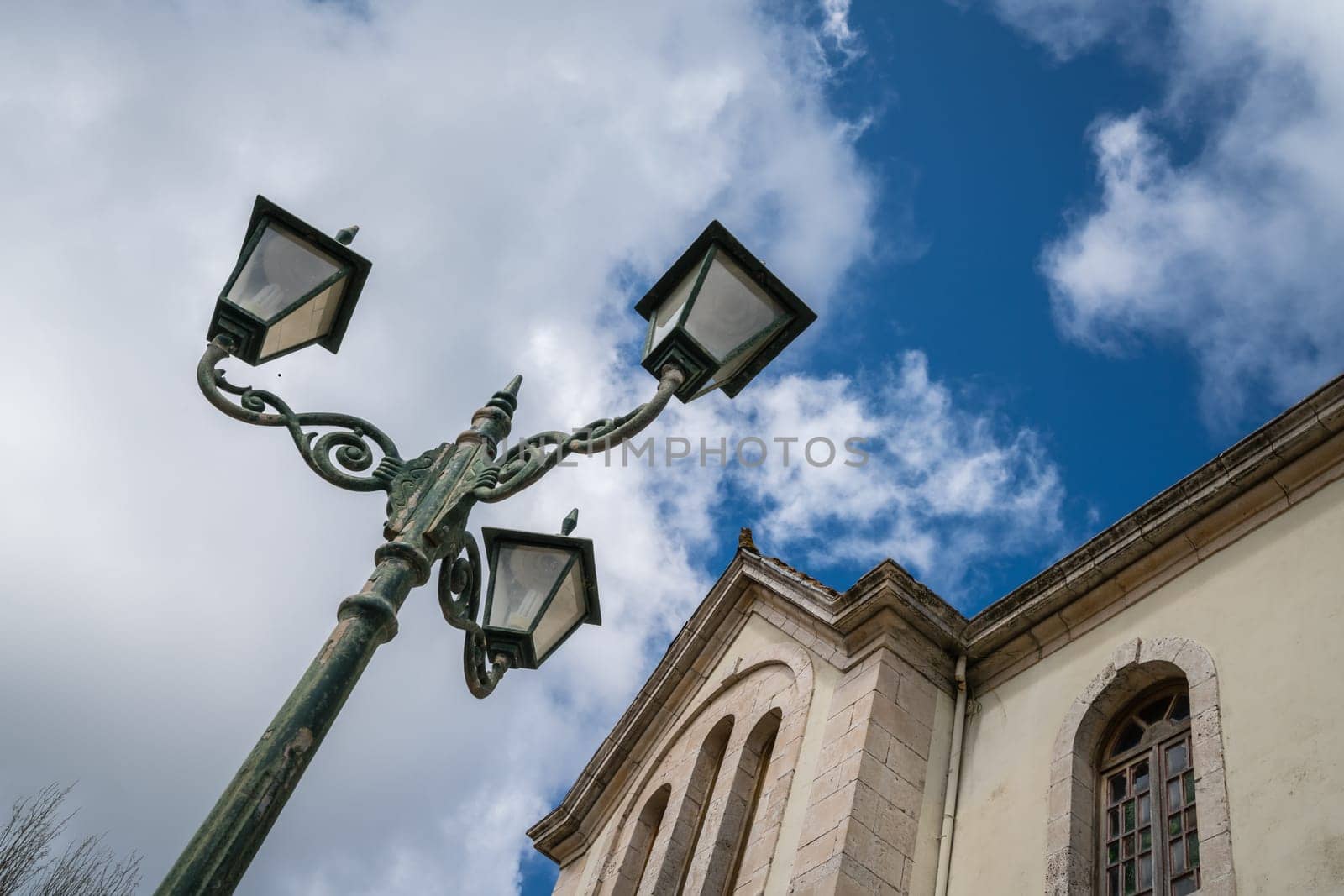 Three way lamppost in front of a small church in Agios Leon village, Zante, Greece